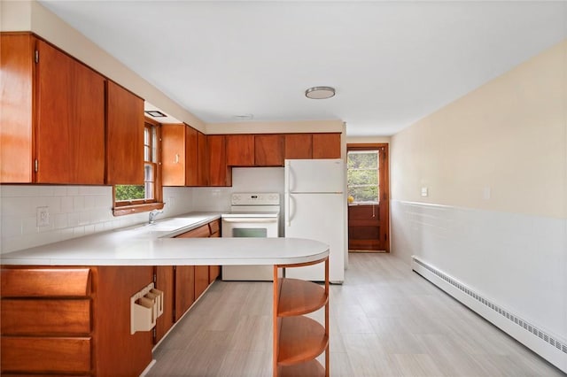 21 Parsonage Dr, Warwick, RI 02889 - kitchen featuring white appliances, a baseboard radiator, brown cabinets, and light countertops