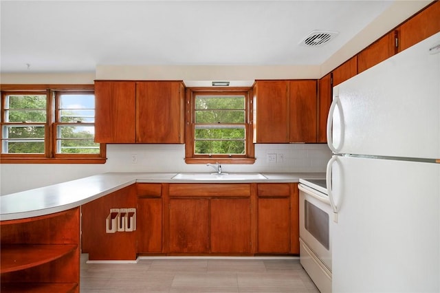 21 Parsonage Dr, Warwick, RI 02889 - kitchen featuring freestanding refrigerator, stove, light countertops, and decorative backsplash