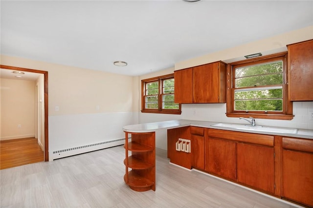 21 Parsonage Dr, Warwick, RI 02889 - kitchen featuring baseboard heating, light countertops, brown cabinets, and open shelves