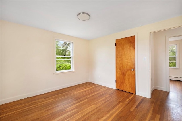 21 Parsonage Dr, Warwick, RI 02889 - spare room with wood finished floors and a baseboard heating unit