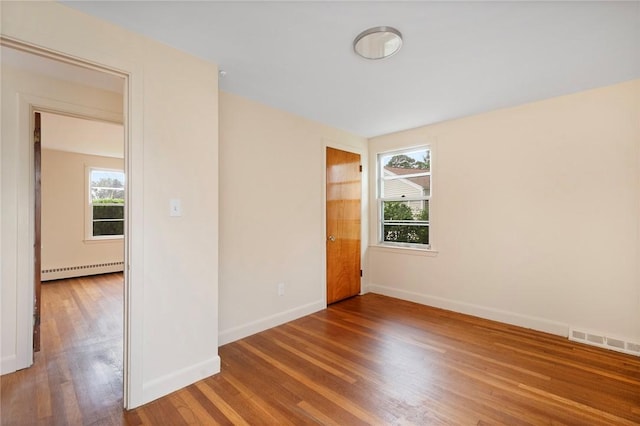 21 Parsonage Dr, Warwick, RI 02889 - unfurnished room with healthy amount of natural light, baseboard heating, and wood finished floors