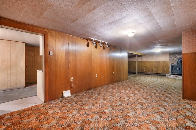 21 Parsonage Dr, Warwick, RI 02889 - finished basement featuring a wood stove, wooden walls, and carpet flooring