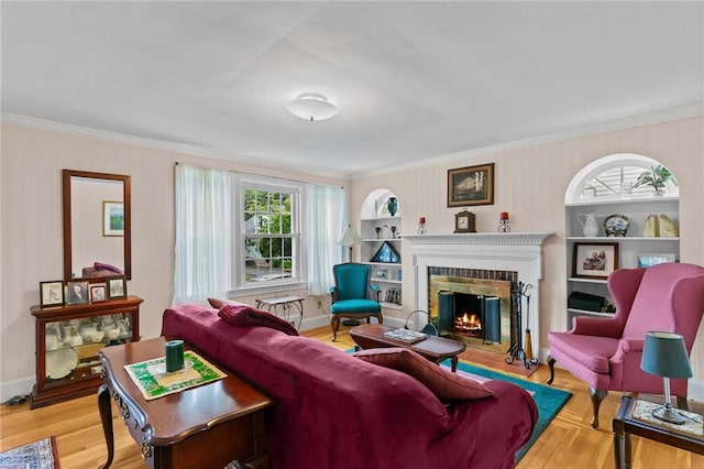 13 Welcome Rd, Smithfield, RI 02917 - living area featuring a glass covered fireplace, healthy amount of natural light, ornamental molding, and wood finished floors