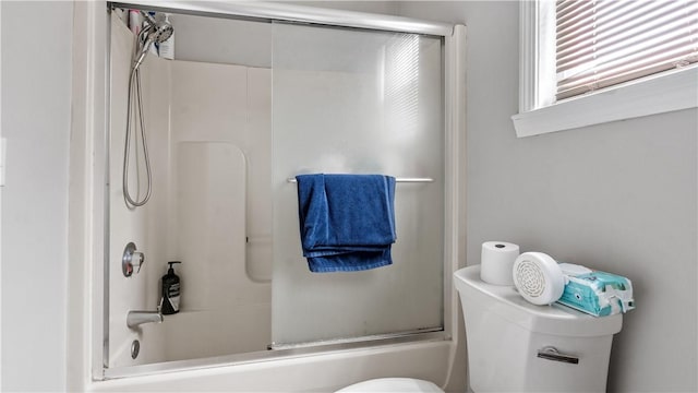 65 River St, West Warwick, RI 02893 - bathroom featuring toilet and combined bath / shower with glass door