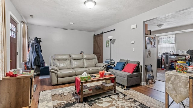 65 River St, West Warwick, RI 02893 - living area with a barn door and wood finished floors