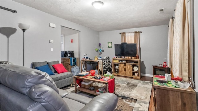 65 River St, West Warwick, RI 02893 - living area featuring a textured ceiling and wood finished floors