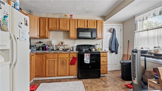 65 River St, West Warwick, RI 02893 - kitchen with black appliances and brown cabinetry