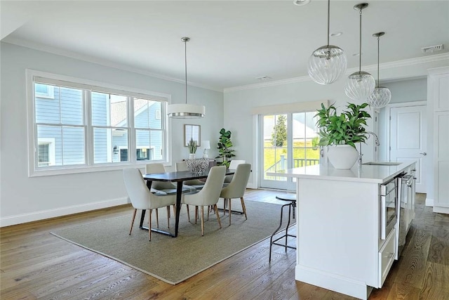 20 Kettle Point Ave, East Providence, RI 02914 - dining room featuring dark wood finished floors and ornamental molding