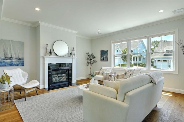 20 Kettle Point Ave, East Providence, RI 02914 - living area featuring a high end fireplace, wood finished floors, recessed lighting, and crown molding