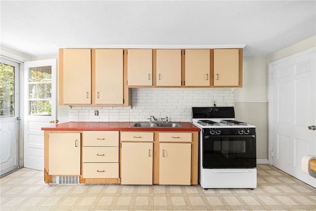15 Preston Dr, North Kingstown, RI 02852 - kitchen with range with gas cooktop, light flooring, and decorative backsplash