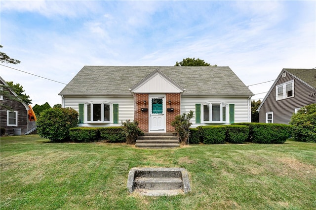 15 Preston Dr, North Kingstown, RI 02852 - view of front of house featuring a front yard, brick siding, and a shingled roof