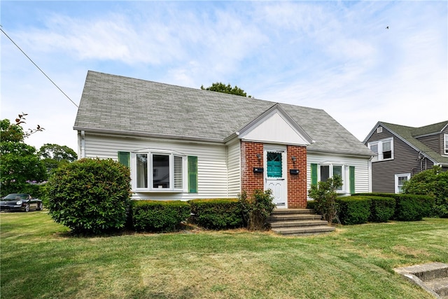 15 Preston Dr, North Kingstown, RI 02852 - view of front facade with a front lawn, brick siding, and a shingled roof