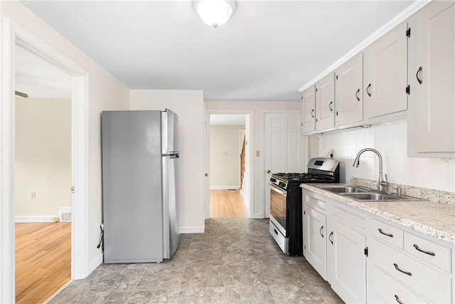 15 Preston Dr, North Kingstown, RI 02852 - kitchen featuring appliances with stainless steel finishes, white cabinetry, and backsplash