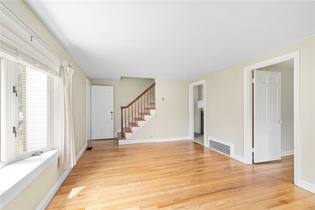 15 Preston Dr, North Kingstown, RI 02852 - empty room with light wood-type flooring, stairway, and plenty of natural light
