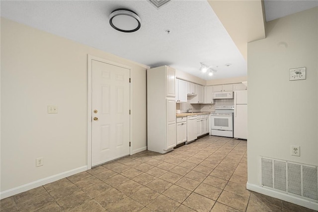 31 Devereux Ave Unit 115, Providence, RI 02909 - kitchen with white appliances, light countertops, and white cabinets