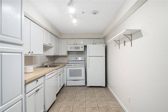 31 Devereux Ave Unit 115, Providence, RI 02909 - kitchen with white appliances, light countertops, white cabinets, and backsplash