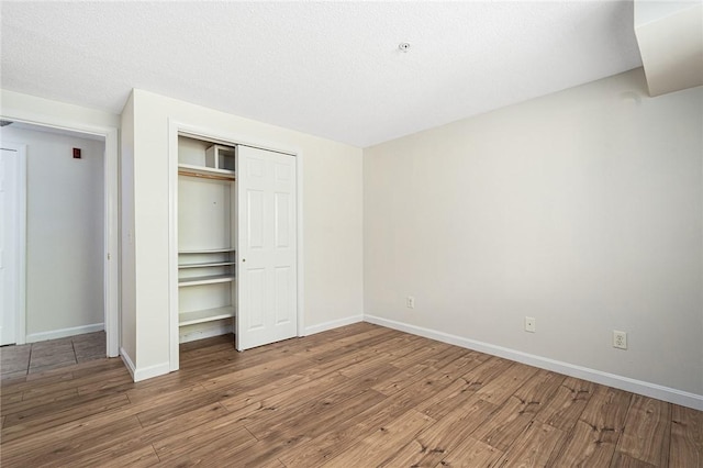31 Devereux Ave Unit 115, Providence, RI 02909 - unfurnished bedroom with wood finished floors and a closet