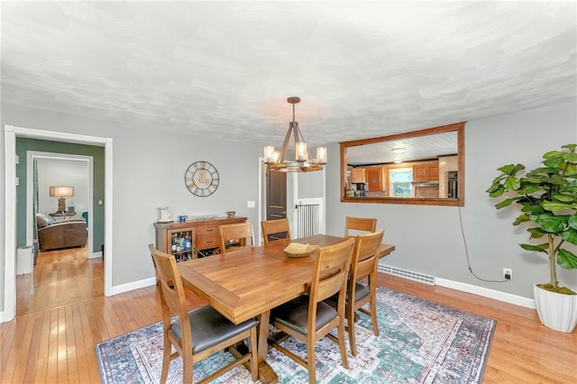 82 Martin St, East Providence, RI 02914 - dining area featuring light wood-style flooring and a chandelier