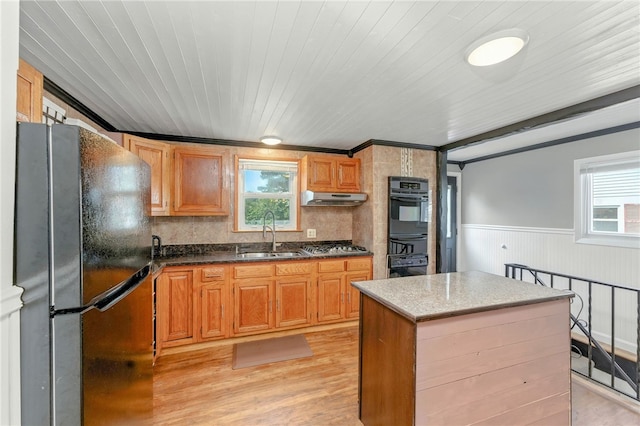 82 Martin St, East Providence, RI 02914 - kitchen with freestanding refrigerator, oven, under cabinet range hood, light wood-style floors, and wainscoting