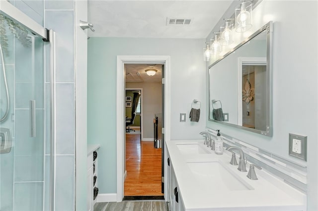 82 Martin St, East Providence, RI 02914 - bathroom with double vanity, wood finished floors, and a shower with door