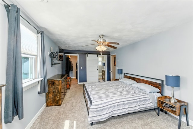 82 Martin St, East Providence, RI 02914 - bedroom featuring a barn door, a spacious closet, carpet, and a ceiling fan