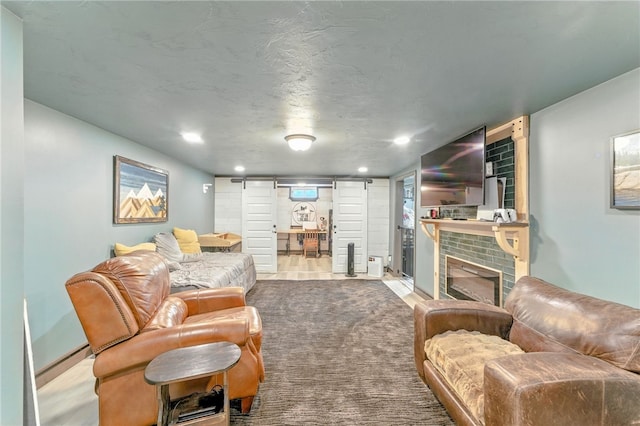 82 Martin St, East Providence, RI 02914 - living room with a brick fireplace, recessed lighting, and a baseboard radiator