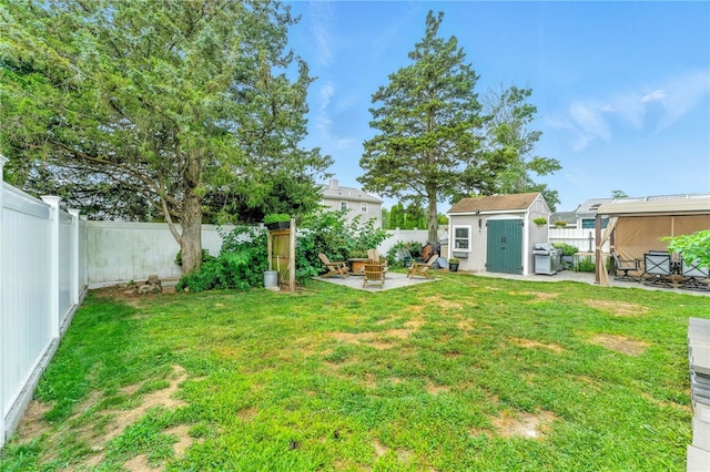 82 Martin St, East Providence, RI 02914 - fenced backyard with an outdoor fire pit, a storage shed, and a patio area
