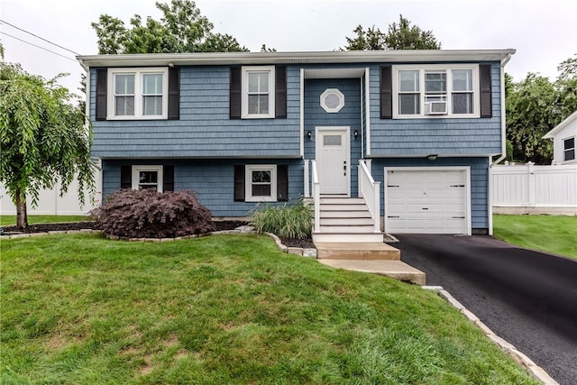 10 Pembroke Dr, Johnston, RI 02919 - bi-level home with an attached garage, asphalt driveway, and cooling unit