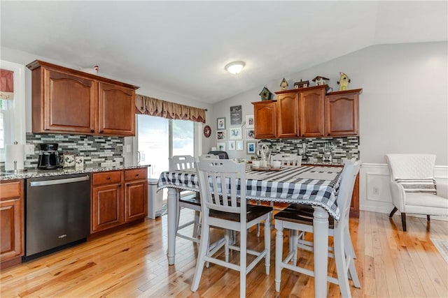 10 Pembroke Dr, Johnston, RI 02919 - kitchen featuring dishwasher, decorative backsplash, light wood-style floors, vaulted ceiling, and light stone counters