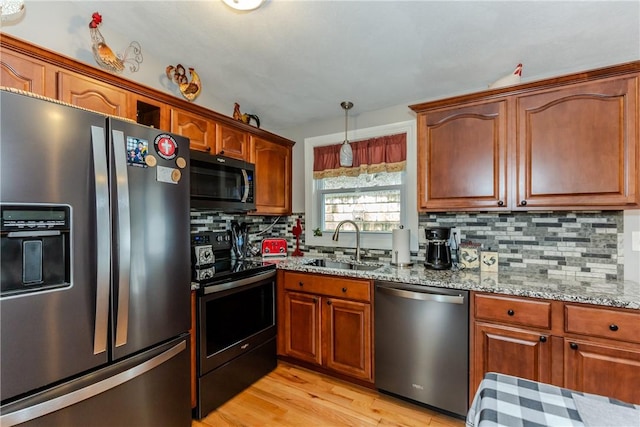 10 Pembroke Dr, Johnston, RI 02919 - kitchen featuring stainless steel appliances, backsplash, light stone counters, light wood-type flooring, and brown cabinetry
