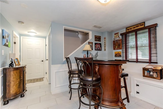 10 Pembroke Dr, Johnston, RI 02919 - indoor dry bar featuring light tile patterned floors, stairs, and wainscoting