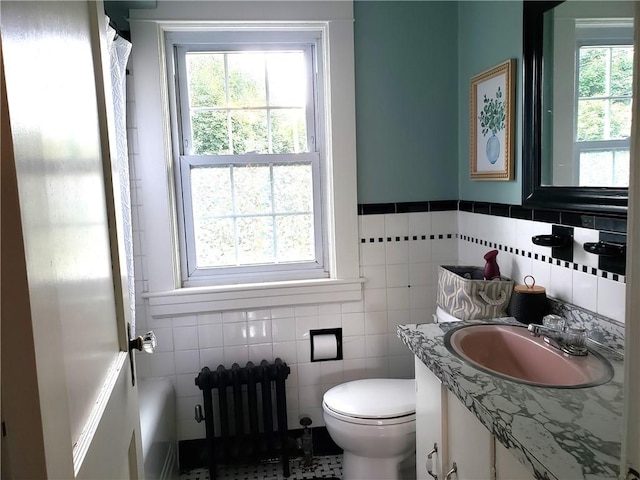603 Wakefield St, West Warwick, RI 02893 - bathroom with vanity, tile walls, radiator heating unit, and a shower with curtain