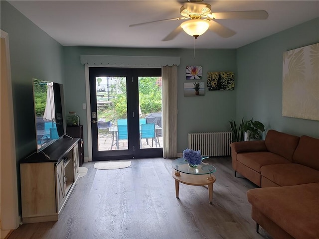 603 Wakefield St, West Warwick, RI 02893 - living room featuring radiator, wood finished floors, and ceiling fan
