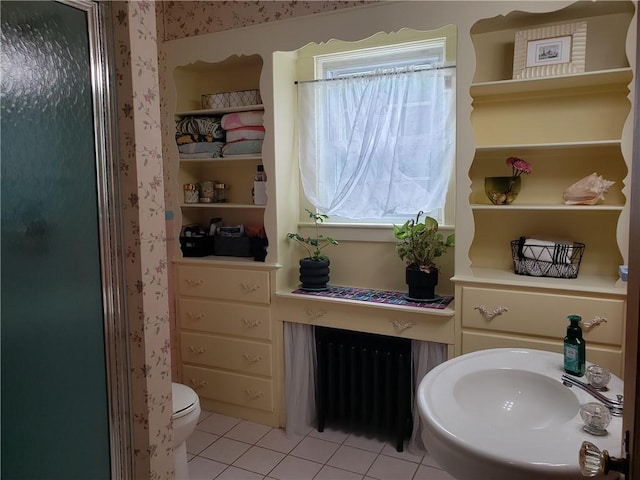 603 Wakefield St, West Warwick, RI 02893 - full bathroom with radiator, tile patterned floors, and a shower with door