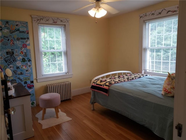 603 Wakefield St, West Warwick, RI 02893 - bedroom with radiator, wood finished floors, and a ceiling fan