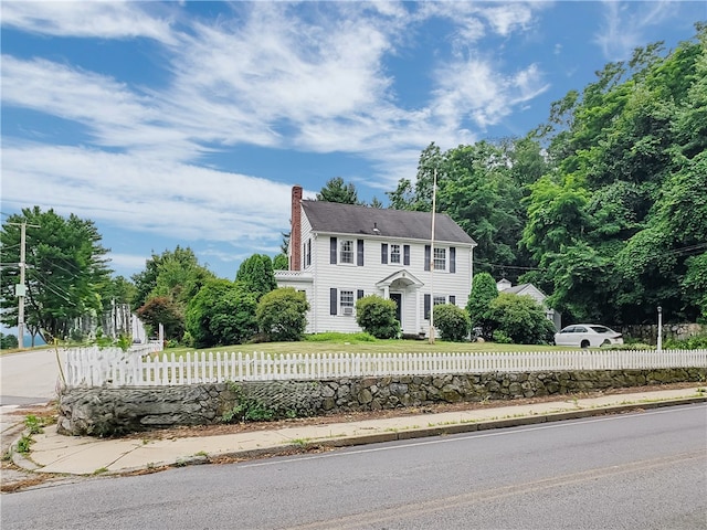 603 Wakefield St, West Warwick, RI 02893 - colonial home featuring a chimney and a fenced front yard