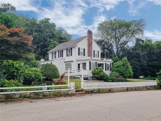 603 Wakefield St, West Warwick, RI 02893 - view of front of house featuring a fenced front yard and a chimney
