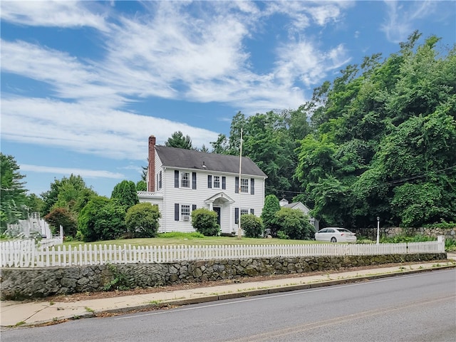 603 Wakefield St, West Warwick, RI 02893 - colonial home featuring a chimney and a fenced front yard