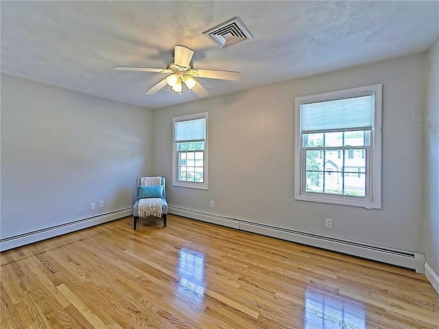 15 Lilac Cir, Cranston, RI 02920 - unfurnished room featuring a baseboard radiator, light wood-style floors, and a ceiling fan
