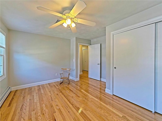 15 Lilac Cir, Cranston, RI 02920 - unfurnished bedroom with a baseboard radiator, light wood-style floors, a ceiling fan, and a closet