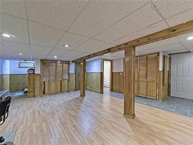 15 Lilac Cir, Cranston, RI 02920 - finished below grade area with a drop ceiling, wood finished floors, wooden walls, and a wainscoted wall