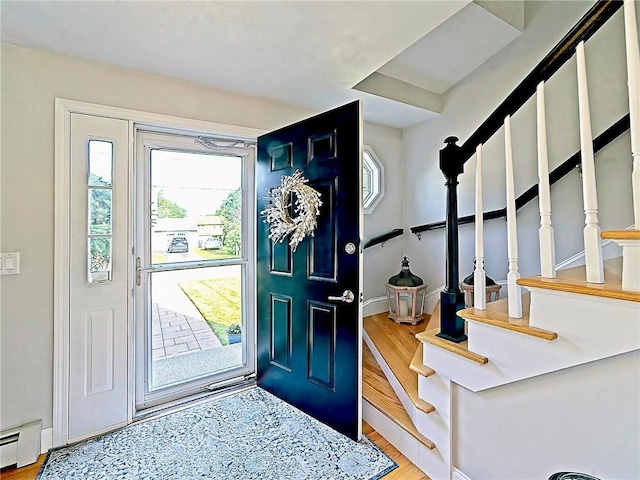 15 Lilac Cir, Cranston, RI 02920 - foyer featuring a baseboard heating unit, wood finished floors, and stairway
