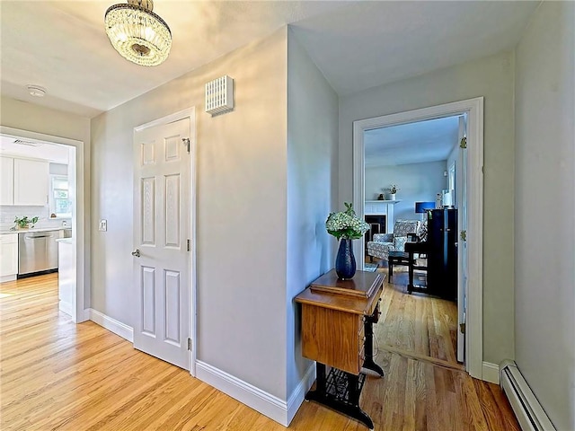 15 Lilac Cir, Cranston, RI 02920 - hall featuring a baseboard heating unit, light wood-style flooring, and a chandelier