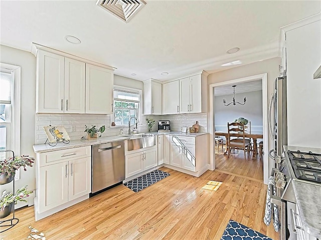 15 Lilac Cir, Cranston, RI 02920 - kitchen featuring appliances with stainless steel finishes, light countertops, white cabinetry, decorative backsplash, and recessed lighting