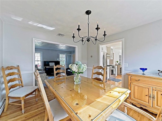 15 Lilac Cir, Cranston, RI 02920 - dining space featuring a chandelier, light wood finished floors, and a baseboard heating unit