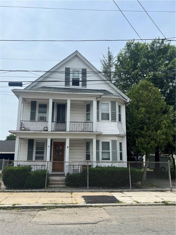 38 Moorefield St, Providence, RI 02909 - view of front facade with a porch, a fenced front yard, and a gate