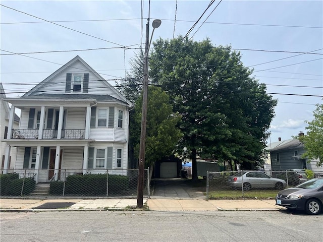 38 Moorefield St, Providence, RI 02909 - view of front of property featuring covered porch, a fenced front yard, and a balcony