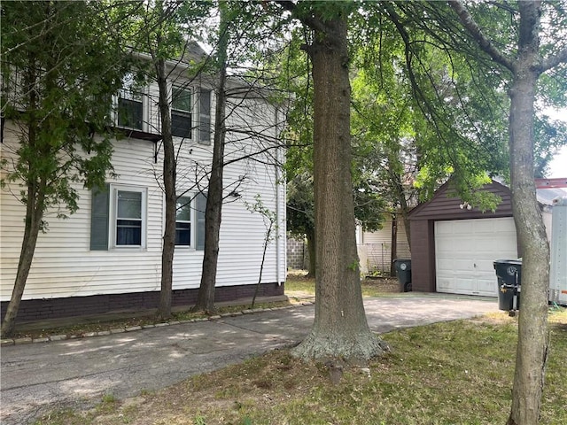 38 Moorefield St, Providence, RI 02909 - view of side of property featuring a detached garage, an outbuilding, and concrete driveway
