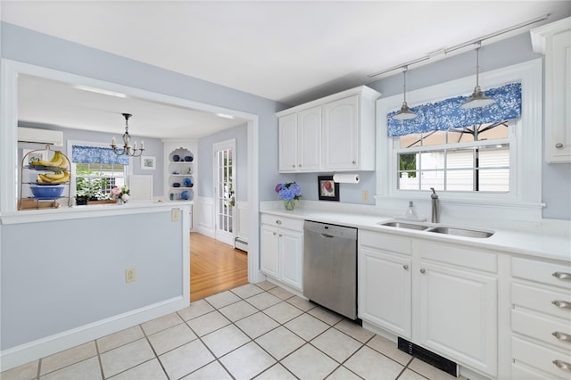 221 Trinity St, Warwick, RI 02886 - kitchen with dishwasher, a chandelier, white cabinets, hanging light fixtures, and light countertops