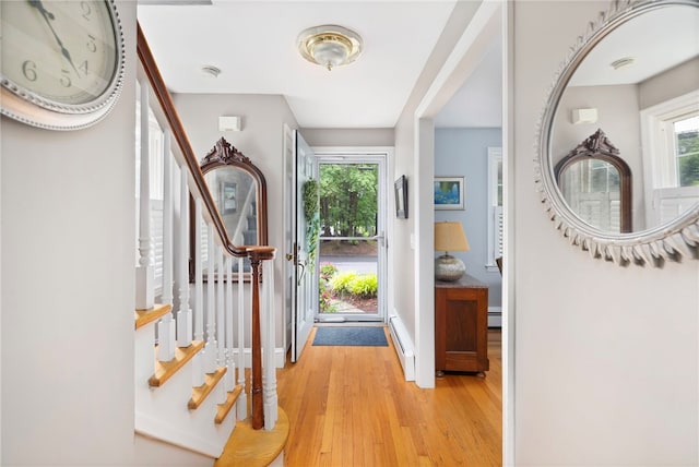 221 Trinity St, Warwick, RI 02886 - foyer featuring light wood-style flooring, stairway, and a baseboard radiator